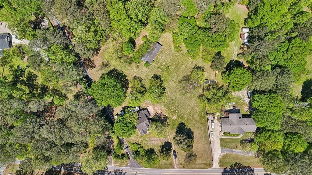 5735 Old Bill Cook Road Atlanta, GA 30349 - Photo 25 of 38 an aerial view of residential house with outdoor space and trees all around