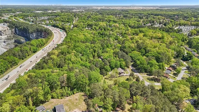 a view of a city with lush green forest