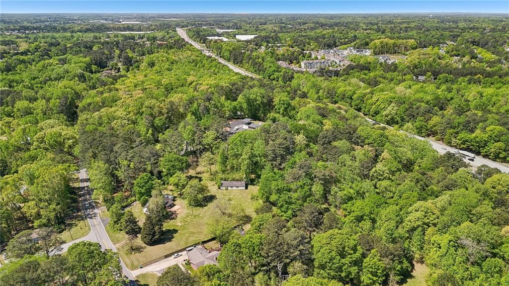 5735 Old Bill Cook Road Atlanta, GA 30349 - Photo 32 of 38 a view of a city with lush green forest