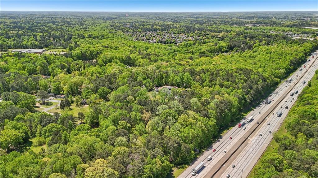 5735 Old Bill Cook Road Atlanta, GA 30349 - Photo 35 of 38 a view of a field with a lush green forest