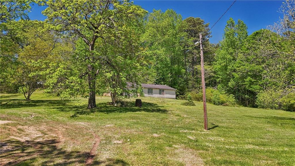 5735 Old Bill Cook Road Atlanta, GA 30349 - Photo 6 of 38 a backyard of a house with lots of green space