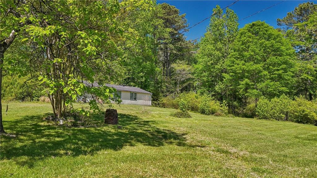 5735 Old Bill Cook Road Atlanta, GA 30349 - Photo 7 of 38 a backyard of a house with lots of green space