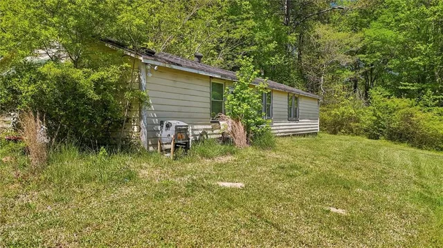 a view of house with backyard