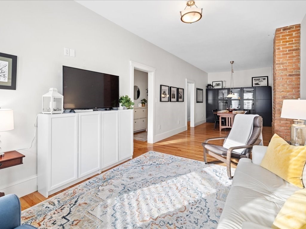 a view of a livingroom with workspace and a couch