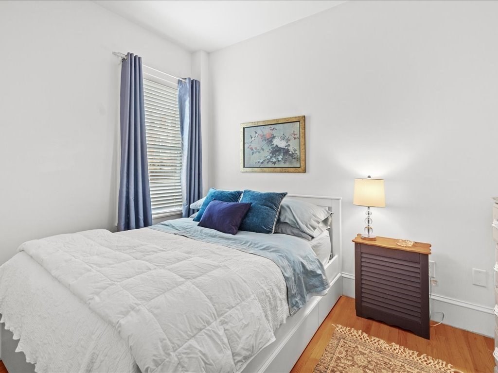 556 East 5th Street, Unit 1 Boston, MA 02127 - Photo 12 of 17 a bedroom with a bed and a night stand