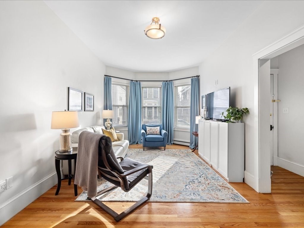 556 East 5th Street, Unit 1 Boston, MA 02127 - Photo 2 of 17 a view of a livingroom with furniture and wooden floor