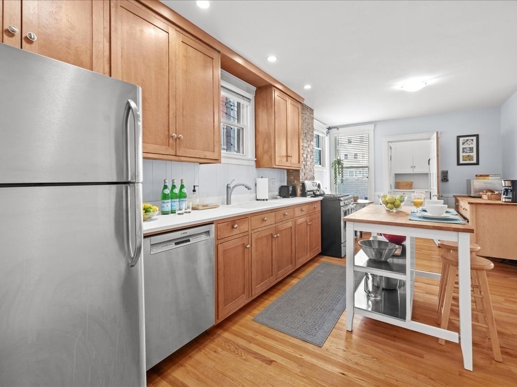 556 East 5th Street, Unit 1 Boston, MA 02127 - Photo 5 of 17 a kitchen with white cabinets and white appliances