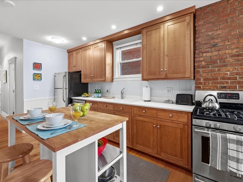 556 East 5th Street, Unit 1 Boston, MA 02127 - Photo 7 of 17 a kitchen with a stove a sink and cabinets