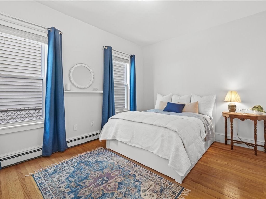 556 East 5th Street, Unit 1 Boston, MA 02127 - Photo 10 of 17 a bedroom with a bed and wooden floor