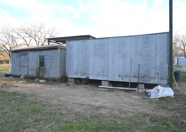a view of a house with a yard and tree s