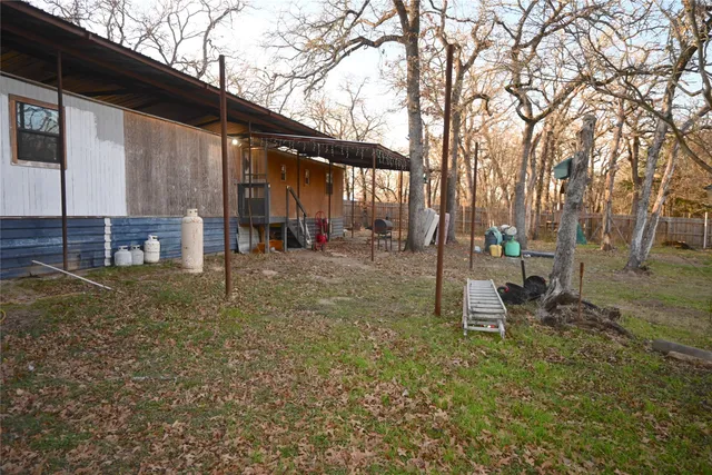 a backyard of a house with table and chairs