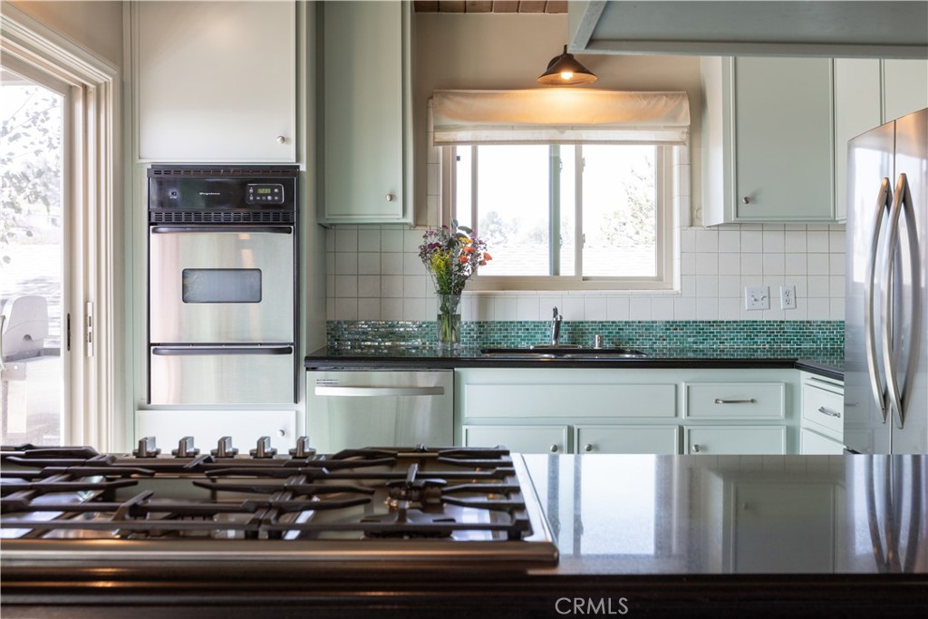 733 Crane Boulevard Los Angeles, CA 90065 - Photo 12 of 30 a kitchen with a stove and a white cabinet