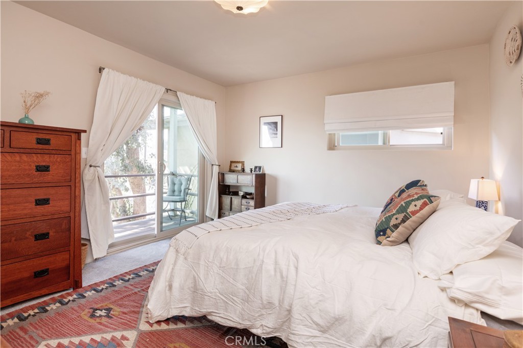 733 Crane Boulevard Los Angeles, CA 90065 - Photo 23 of 30 a bedroom with a bed and large windows