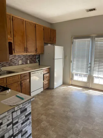 a kitchen with stainless steel appliances a stove a sink and a refrigerator