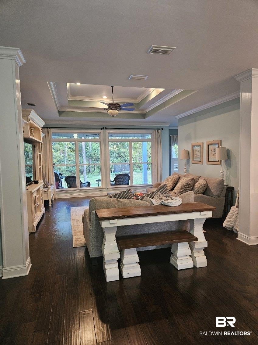 41416 Davis Duck Road Bay Minette, AL 36507 - Photo 17 of 72 Living room featuring ceiling fan, crown molding, dark wood-type flooring, and a tray ceiling