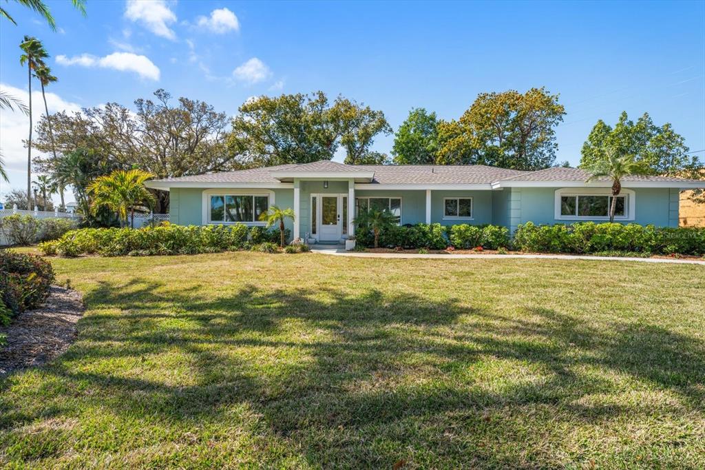 a front view of house with yard and green space
