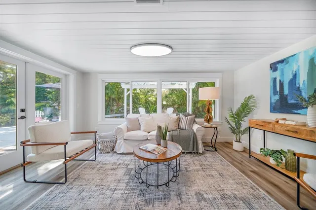 a living room with furniture a fireplace and a large window