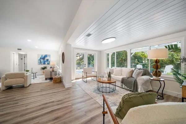 a living room with furniture and large windows