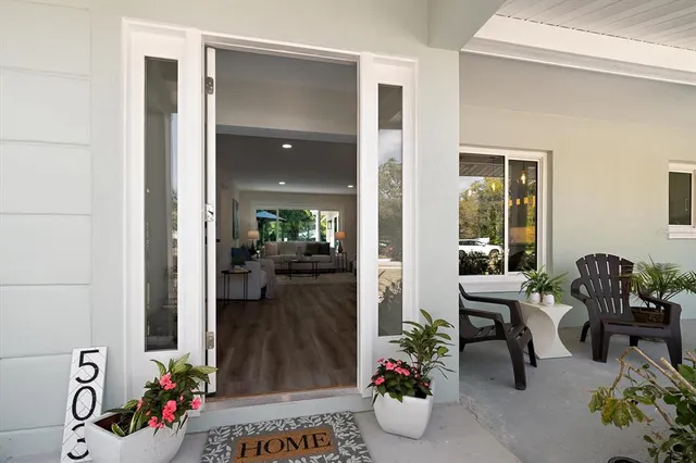a living room with furniture and flowers