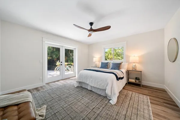 a bedroom with a large bed and a chandelier