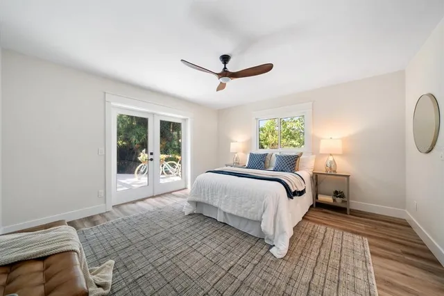 a bedroom with a large bed and a chandelier