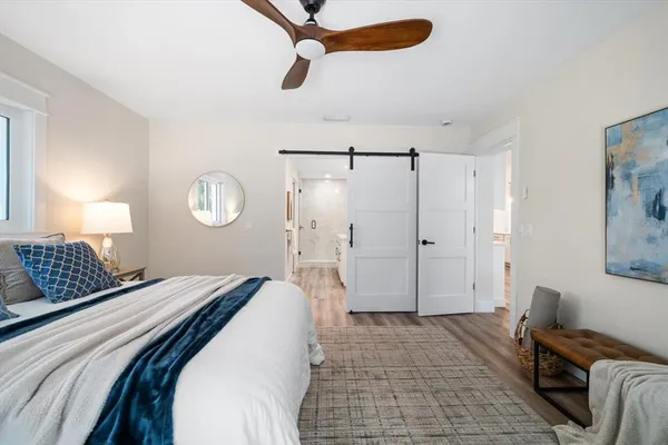 a bedroom with a bed and a window