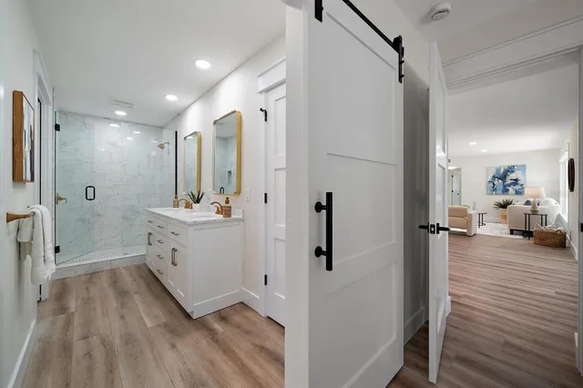 a bathroom with a double vanity sink and mirror