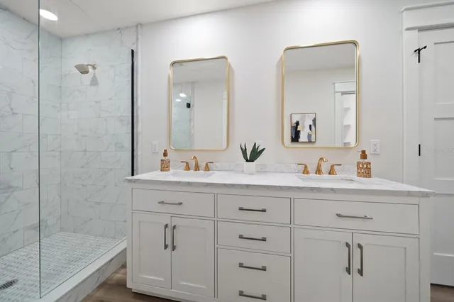 a bathroom with a shower sink and mirror