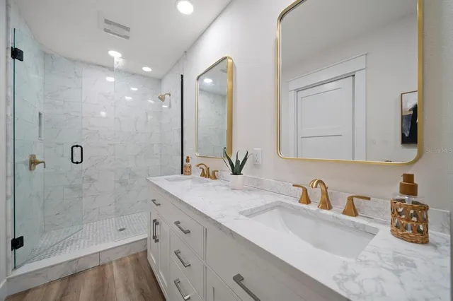 a bathroom with a shower sink and mirror