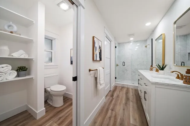 a bathroom with a sink toilet a shower and a mirror