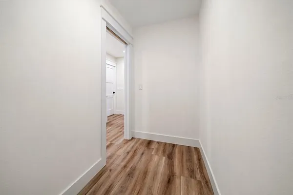 a view of a room with wooden floor and white walls