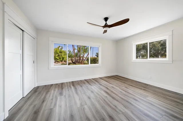 wooden floor in an empty room with a window