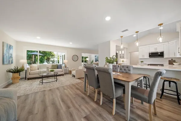 a living room with furniture and kitchen view