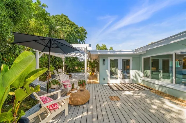 a view of a house with backyard sitting area and garden