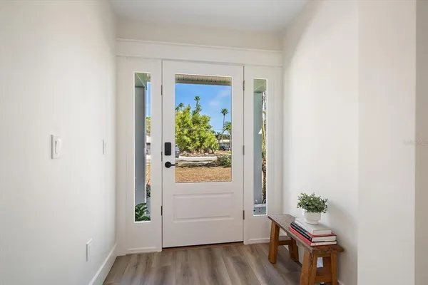 a room with wooden floor and a hallway