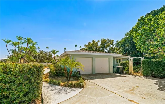 a front view of house with yard seating and green space