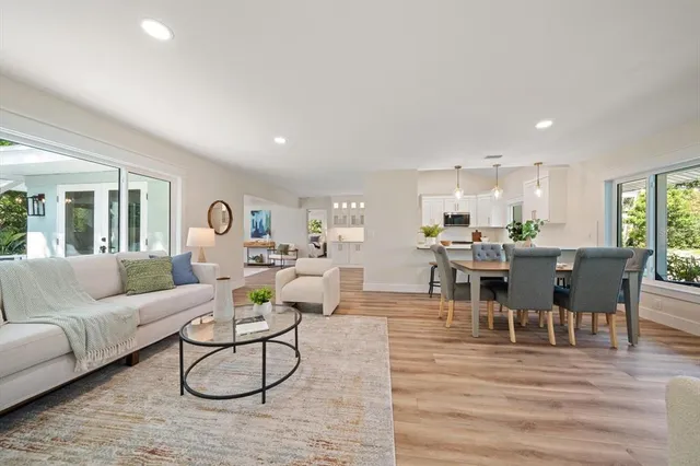 a living room with furniture kitchen view and a dining table