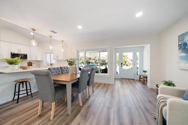 a living room with furniture dining table and a large window