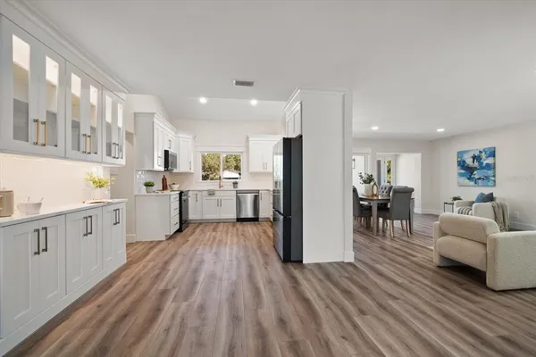 a kitchen with white cabinets and stainless steel appliances