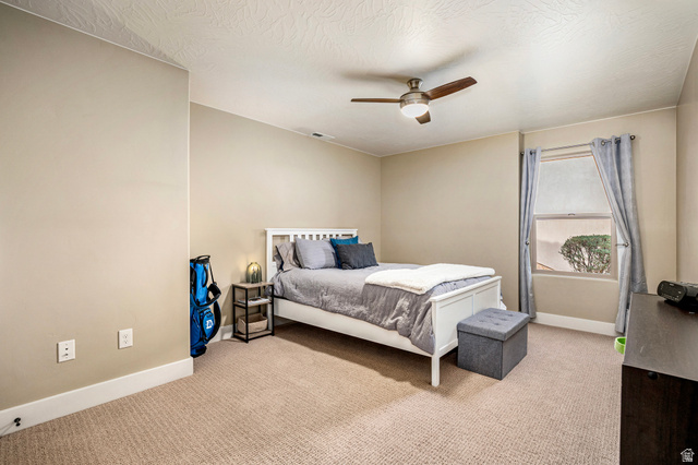 2311 South 1340 West St. George, UT 84770 - Photo 46 of 56 Bedroom featuring light carpet, ceiling fan, and a textured ceiling
