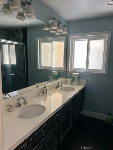 a bathroom with a double vanity sink and a mirror