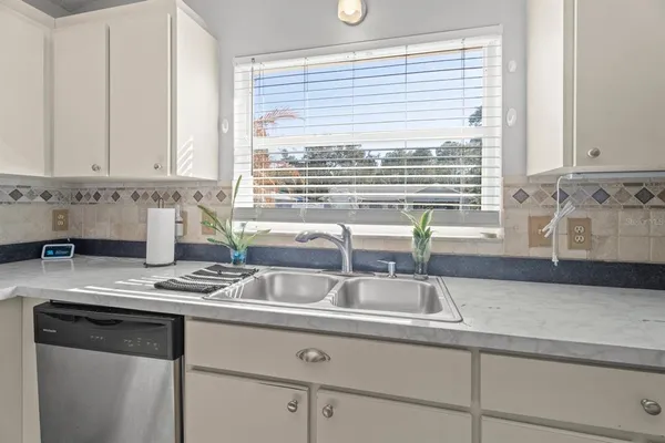 a kitchen with granite countertop a sink and a window