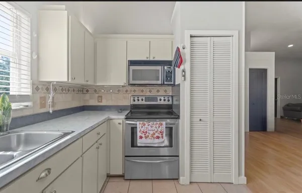 a kitchen with stainless steel appliances granite countertop a sink and a stove
