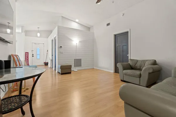 a living room with furniture and a wooden floor