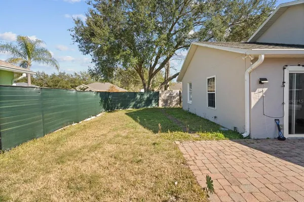 a view of a backyard with plants and lake view