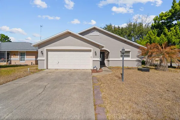 a view of a house with a yard and garage