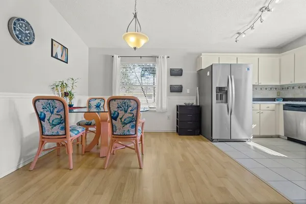 a view of a dining room with furniture and a wooden floor