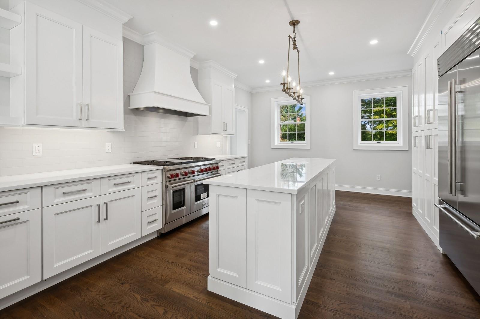 45 Durham Road Bronxville, NY 10708 - Photo 16 of 25 Kitchen featuring white cabinets, high end appliances, a center island, and custom exhaust hood