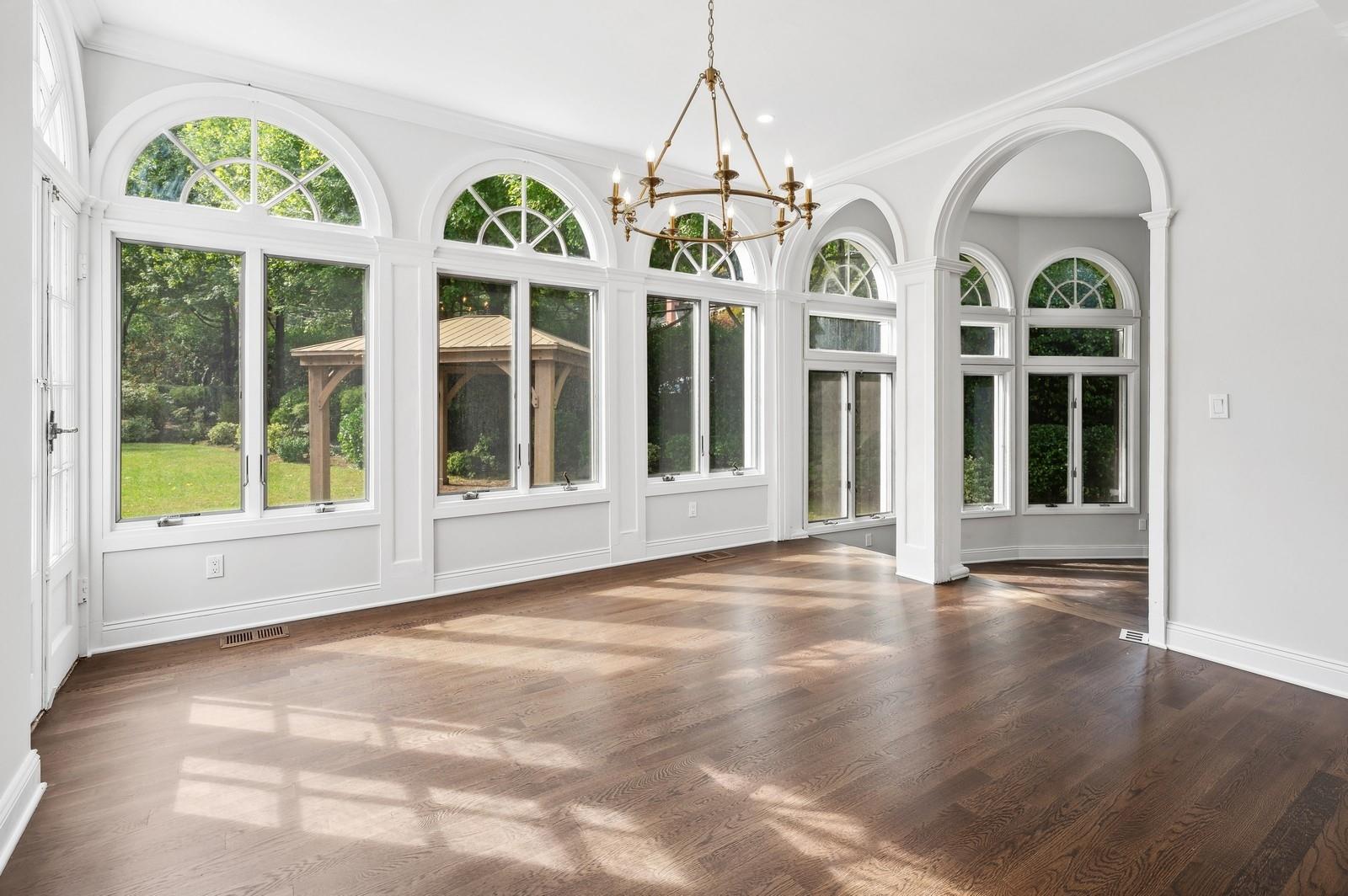 45 Durham Road Bronxville, NY 10708 - Photo 17 of 25 Unfurnished sunroom with a notable chandelier