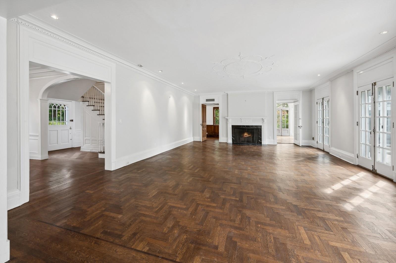 45 Durham Road Bronxville, NY 10708 - Photo 10 of 25 Unfurnished living room with ornamental molding, plenty of natural light, and dark parquet floors
